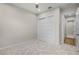 Bright bedroom with carpet, closet, and doorway to a room with wood floors at 1475 Warrior Trl, Enterprise, FL 32725