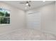 Neutral bedroom with carpet has a ceiling fan, and window offering outdoor views at 1475 Warrior Trl, Enterprise, FL 32725
