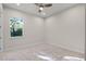 Minimalist bedroom with carpet flooring, a ceiling fan, and a large window offering ample natural light at 1475 Warrior Trl, Enterprise, FL 32725