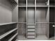 Spacious walk-in closet featuring shelving and drawers for organized storage solutions at 1475 Warrior Trl, Enterprise, FL 32725