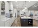 Bright, open kitchen with island seating, modern appliances, and ample cabinet space at 1475 Warrior Trl, Enterprise, FL 32725