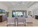 Bright and spacious living room featuring large windows and access to the outdoor area at 1475 Warrior Trl, Enterprise, FL 32725