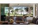 Open living room with sliding glass doors leading to a screened patio with lake views at 1475 Warrior Trl, Enterprise, FL 32725