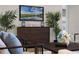 Stylish living room with a modern console, plants, and cozy decor at 1475 Warrior Trl, Enterprise, FL 32725