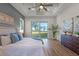 This bright main bedroom offers stunning water views and access to the backyard at 1475 Warrior Trl, Enterprise, FL 32725