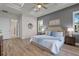 The main bedroom features a tray ceiling, bedside lamps, and an ensuite bathroom at 1475 Warrior Trl, Enterprise, FL 32725