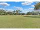 Open green pasture with equestrian obstacles and wooden fencing, perfect for training and recreation at 1475 Warrior Trl, Enterprise, FL 32725