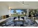 Elegant covered patio featuring stylish furniture and scenic lake views at 1475 Warrior Trl, Enterprise, FL 32725
