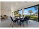 Spacious covered patio with a dining table and scenic views of the lake at 1475 Warrior Trl, Enterprise, FL 32725