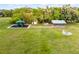 Community recreation area featuring a playground, picnic shelter and fire pit, all on a lush green lawn at 1475 Warrior Trl, Enterprise, FL 32725