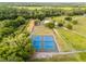 Aerial shot showcasing the property's well-maintained tennis courts surrounded by lush greenery at 1475 Warrior Trl, Enterprise, FL 32725