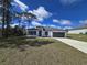 Charming single-story home featuring a two-car garage and manicured lawn, all under a beautiful sky at 15462 Sw 46 Cir, Ocala, FL 34473