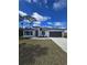Charming one-story home with a well-maintained lawn, gray roof, and modern design at 15462 Sw 46 Cir, Ocala, FL 34473