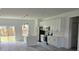 Modern kitchen with white cabinets, stainless steel appliances, and an open design leading to the backyard at 15462 Sw 46 Cir, Ocala, FL 34473