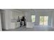 Open-concept kitchen with stainless steel appliances, island, and sliding glass doors to the exterior at 15462 Sw 46 Cir, Ocala, FL 34473