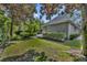 Beautifully landscaped backyard featuring lush greenery, mature trees, and a serene outdoor space at 1741 Pine Ave, Winter Park, FL 32789