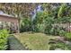 Beautifully landscaped backyard featuring lush greenery and mature trees at 1741 Pine Ave, Winter Park, FL 32789