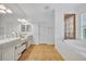 Luxurious bathroom with double vanity sinks and a soaking tub at 1741 Pine Ave, Winter Park, FL 32789
