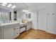 Bright bathroom featuring double sinks, vanity, ample lighting, and neutral color palette at 1741 Pine Ave, Winter Park, FL 32789