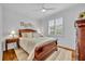 Cozy bedroom featuring a plush bed, hardwood floors, and natural light from the window at 1741 Pine Ave, Winter Park, FL 32789
