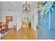 Bright foyer featuring hardwood floors, an elegant chandelier, and a glimpse into the open-concept living space at 1741 Pine Ave, Winter Park, FL 32789