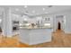 Open kitchen featuring a large island, stainless steel appliances, and white cabinetry at 1741 Pine Ave, Winter Park, FL 32789