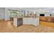 Open kitchen with granite countertops connects to a comfortable living area at 1741 Pine Ave, Winter Park, FL 32789