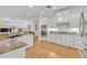 Spacious kitchen with granite countertops, white cabinets and stainless appliances at 1741 Pine Ave, Winter Park, FL 32789