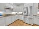 Kitchen with stainless steel appliances, granite countertops, and white cabinetry at 1741 Pine Ave, Winter Park, FL 32789
