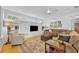Comfortable living room featuring built-in shelving, hardwood floors, and a seating arrangement at 1741 Pine Ave, Winter Park, FL 32789