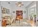 Comfortable living room featuring a bookcase, hardwood floors, and natural light from a window at 1741 Pine Ave, Winter Park, FL 32789