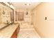 Elegant bathroom featuring double vanity with granite countertop and glass vessel sinks at 1770 Nordic Ct, Apopka, FL 32712