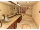 Elegant bathroom featuring double vanity with granite countertop, glass vessel sinks, and a soaking tub at 1770 Nordic Ct, Apopka, FL 32712