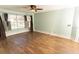 Light-filled bedroom with hardwood floors and a large window overlooking the pool at 1770 Nordic Ct, Apopka, FL 32712