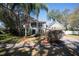 Charming two-story home with lush landscaping, mature trees and ample curb appeal on a sunny day at 1770 Nordic Ct, Apopka, FL 32712