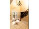 Elegant foyer featuring soaring ceilings, decorative tile flooring, and a grand staircase with chandelier at 1770 Nordic Ct, Apopka, FL 32712