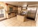 Spacious kitchen with stainless steel appliances, center island, granite countertops, and tile flooring at 1770 Nordic Ct, Apopka, FL 32712