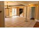 Open living space featuring tile floors, decorative columns, and a clear view of the home's staircase at 1770 Nordic Ct, Apopka, FL 32712
