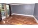 Well-lit living room featuring wood flooring, neutral walls, and sheer curtains at 1770 Nordic Ct, Apopka, FL 32712