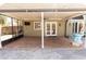 Covered patio featuring brick pavers, a ceiling fan, screened enclosure and an exterior door at 1770 Nordic Ct, Apopka, FL 32712