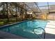 Sparkling screened-in pool featuring a ladder and a spacious deck surrounded by a fence at 1770 Nordic Ct, Apopka, FL 32712