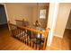 Wooden staircase featuring elegant railings and a view of the home's entrance with decorative chandelier at 1770 Nordic Ct, Apopka, FL 32712