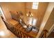 Staircase with wood treads and black iron balusters leading to upper level, with a chandelier overhead at 1770 Nordic Ct, Apopka, FL 32712