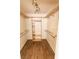 Spacious walk-in closet featuring wood-look flooring and custom shelving at 1770 Nordic Ct, Apopka, FL 32712