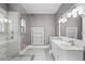 Contemporary bathroom with dual sinks, sleek cabinets, and a glass enclosed walk-in shower with marble-style tiling at 1900 Garvin St, Orlando, FL 32803
