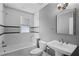 Updated bathroom features a shower-tub, tiled walls, and new vanity with modern fixtures at 1900 Garvin St, Orlando, FL 32803