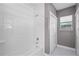 Bathroom featuring tiled shower and tub, white subway tiles, and a window with a view at 1900 Garvin St, Orlando, FL 32803