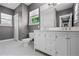 Bathroom with a double vanity, bright lighting, and a separate toilet and shower room at 1900 Garvin St, Orlando, FL 32803