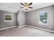 Bright bedroom featuring two windows, neutral walls, carpet, and a ceiling fan at 1900 Garvin St, Orlando, FL 32803