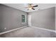 Neutral bedroom with plush carpet, ceiling fan, and natural light from the window at 1900 Garvin St, Orlando, FL 32803